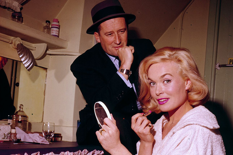 Mickey Spillane, in the role of his creation Mike Hammer, on the set of “The Girl Hunters” (1963) with co-star Shirley Eaton.